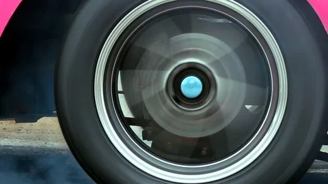 Drag racing car burns rubber off its tires in preparation for the race. Stock Footage 84484936
