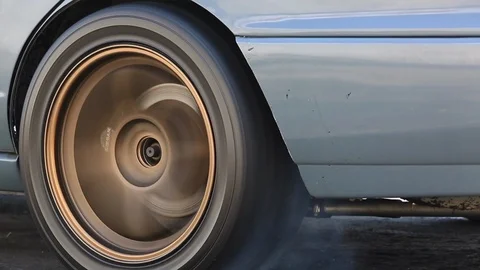 Drag racing car burns rubber off its tires in preparation for the race Stock Footage 85679748