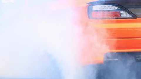 Drag racing car burns rubber off its tires in preparation for the race Stock Footage 85679797