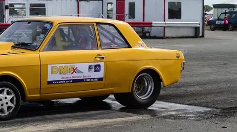 Drag racing driver warming up tyres at start of race, york raceway uk Stock Footage 63662737