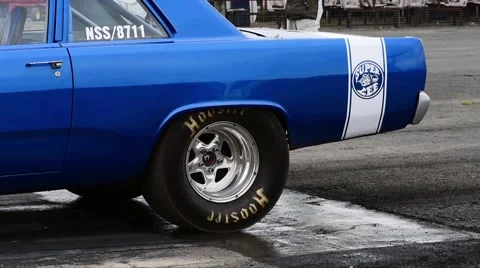 Drag racing driver warming up tyres at start of race, york raceway uk Stock Footage 63663955