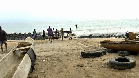 Dragging pirogue to the beach Stock Footage 88129903