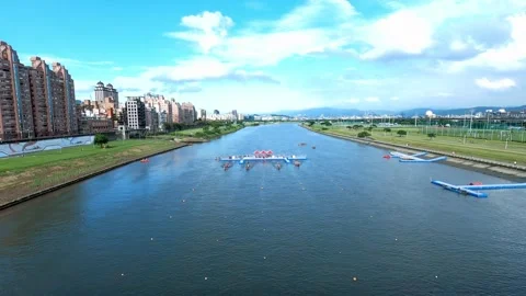 Dragon boat team racing under sun in Taipei filmed from low close angle Stock Footage 309499485