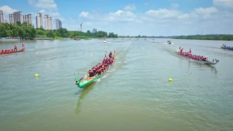 Dragon Boat team rowing to the pace of an onboard Drummer yueyang miluo Stock Footage 325173941