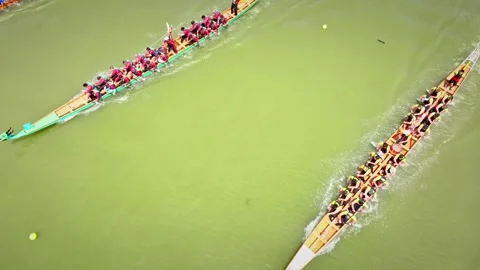 Dragon Boat team rowing to the pace of an onboard Drummer yueyang miluo Stock Footage 325174225
