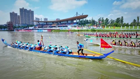 Dragon Boat team rowing to the pace of an onboard Drummer yueyang miluo Stock Footage 325174357