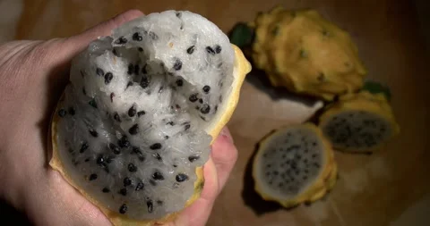 Dragon fruit being squeezed by hands, close-up Stock Footage 301017262