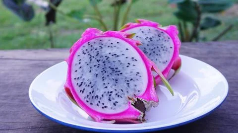 Dragon fruit, cut in half, put on a plate for a snack Stock Photos