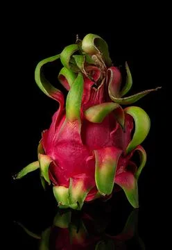 Dragon fruit vertically on a black background Stock Photos
