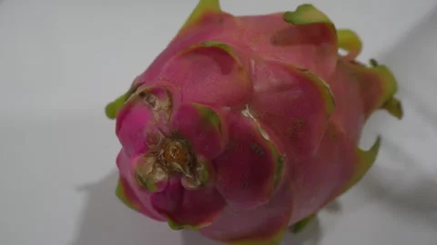 Dragon fruit on white table indoor. Hand pick up the fruit. Food concept Stock Footage 251696611