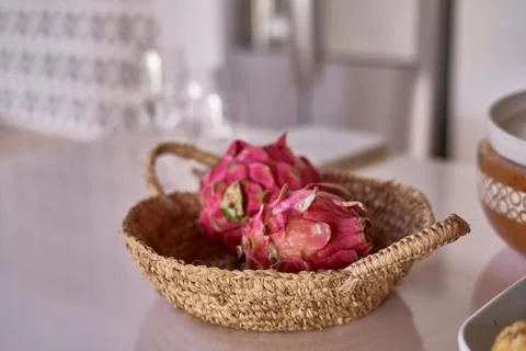 Dragon fruit in a wicker basket on the table Stock Photos