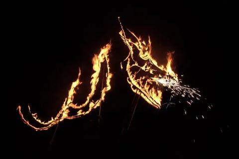 Dragon silhouette in fire Stock Photos