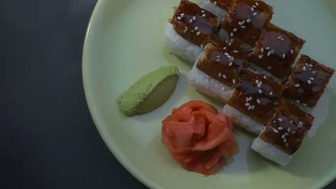 "Dragon" square sushi rolls with eel, salmon, cucumber, nori, sushi rice, sesame Stockbeeldmateriaal 75033801