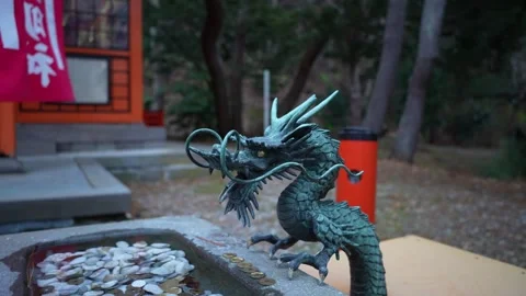 Dragon statue at shrine basin Medium Shot in Hachimangu Shrine Hakodate Japan 動画素材 324958643