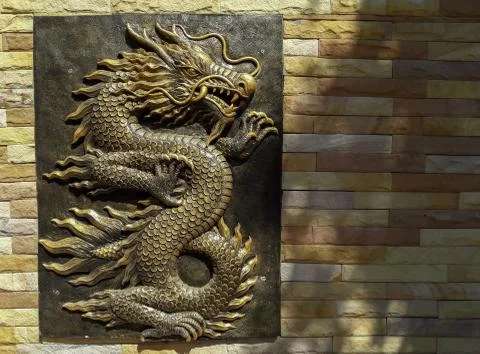 Dragon statue on the wall for a background image. Stock Photos