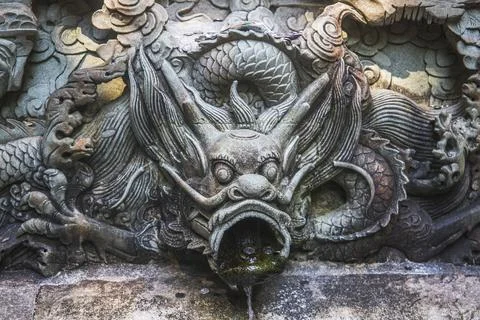 A dragon statue on a wall Stock Photos