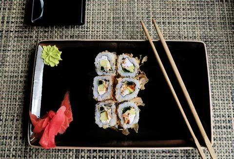 Dragon sushi roll with smoked eel, cucumber, avocado, cream cheese, wasabi and Stock Photos