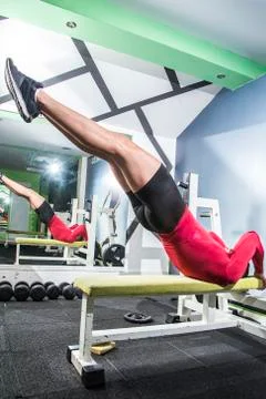 Dragonfly exercise on a bench in the gym Stock Photos