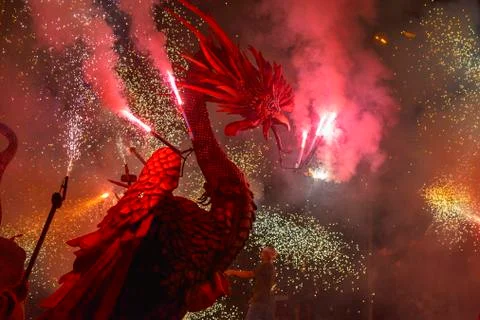 Dragons and devils armed with fireworks dance Stock Photos
