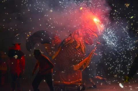 Dragons and devils armed with fireworks dance Stock Photos