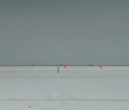 Dragster passes camera at high speed on Bonneville salt Flats Stock Footage 21642569