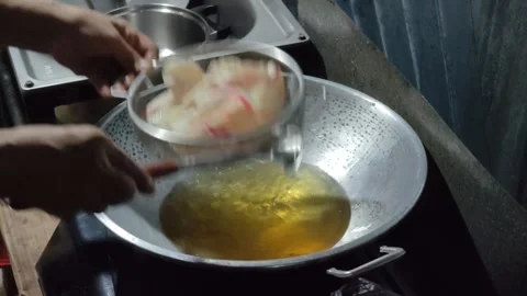 Drain the crackers from the oil Stock Footage 274517207