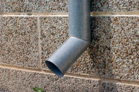 Drain from gray galvanized sheet. Stock Photos