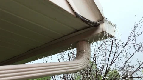 Drain from gutter clogged on house overflowing slow motion Stock Footage 62760551