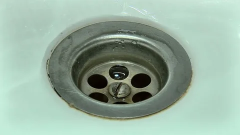The drain hole in the sink with water Stock Footage 75616396