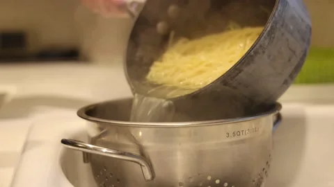 Drain Pasta In Kitchen Slow Motion 스톡 동영상 233457293