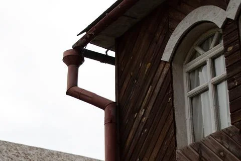 Drain pipe and window of old house Stock Photos
