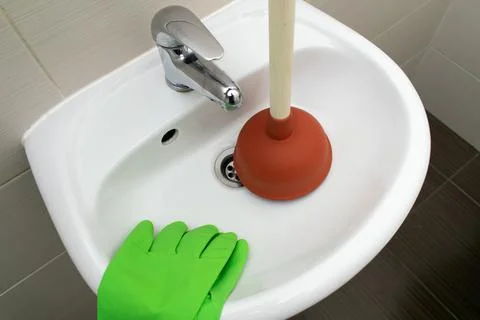 Drain Problems, blockage plumbing bathroom sink unclog plunger force cup Stock Photos