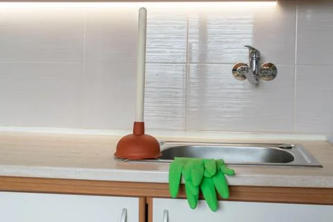 Drain Problems, blockage plumbing kitchen sink unclog plunger force cup Stock Photos