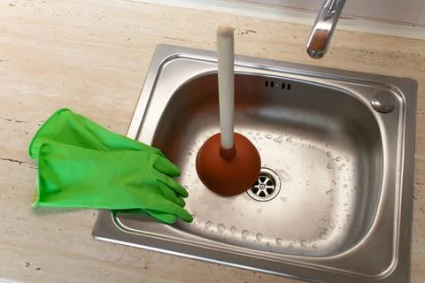 Drain Problems, blockage plumbing kitchen sink unclog plunger force cup Stock Photos