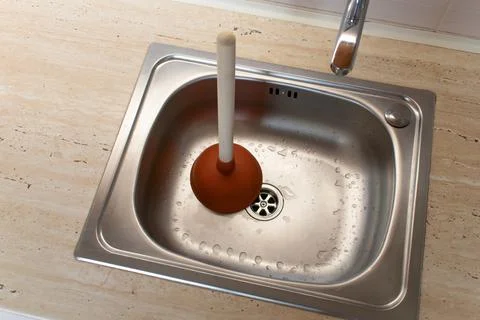 Drain Problems, blockage plumbing kitchen sink unclog plunger force cup Stock Photos
