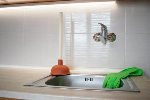 Drain Problems, blockage plumbing kitchen sink unclog plunger force cup Stock Photos