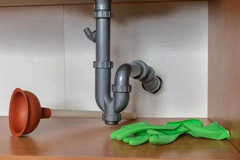Drain Problems, blockage plumbing kitchen sink pipe unclog plunger drainage Stock Photos