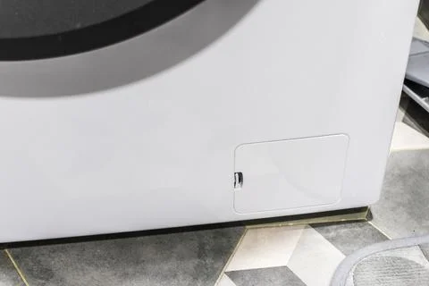 The drain pump filter access panel of the front loading washing machine. Ho.. Photos