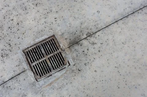 Drain on sidewalk Stock Photos