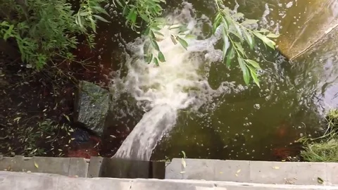 Drain water from the sewer into the river 스톡 동영상 78030517