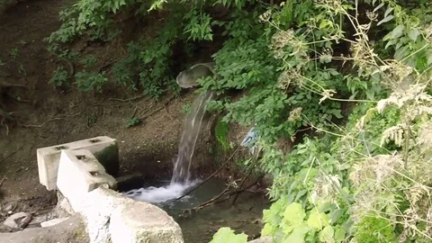 Drain water from the sewer into the river Stock Footage 78030624