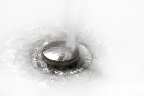 Drain in a white sink, background, close-up Stock Photos