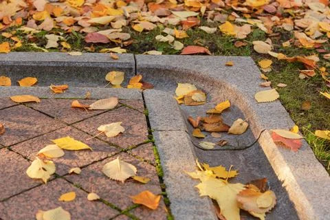 Drainage gutter on the edge of the pavement of natural granite stone. Smooth  Stock Photos