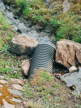 Drainage Pipe Under Small Stream with Natural Ground Surroundings Stock Photos