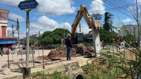 Drainage repair work using excavator in Narathiwat Stock Footage 324883779