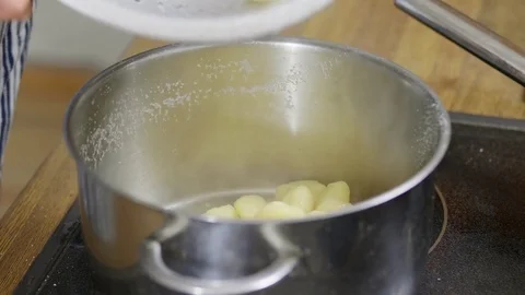 Drained cooked gnocchi being returned into a pot Stock Footage 84554755