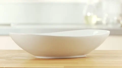 Drained spaghetti being placed in a bowl Stock Footage 24634725