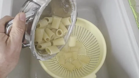 Draining Cooked Pasta into a Colander in Kitchen Sink Stock Footage 320396514