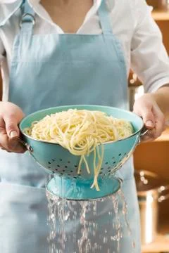 Draining cooked spaghetti Stock Photos