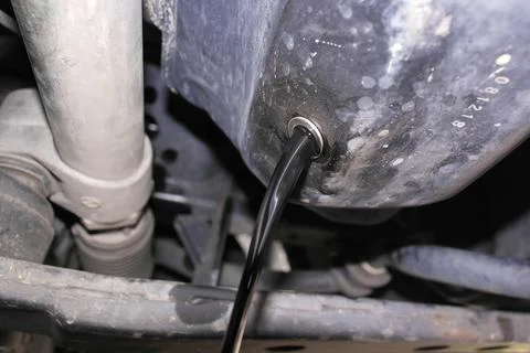 Draining Old Engine Oil for Car Engine Maintenance Stock Photos